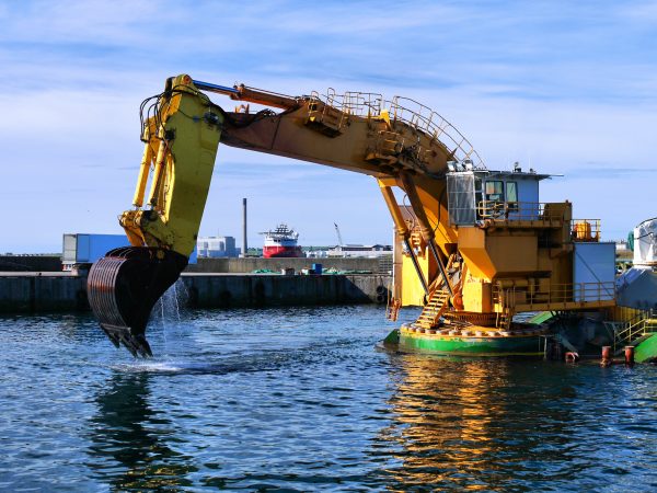 Backhoe Dredger Working in harbor